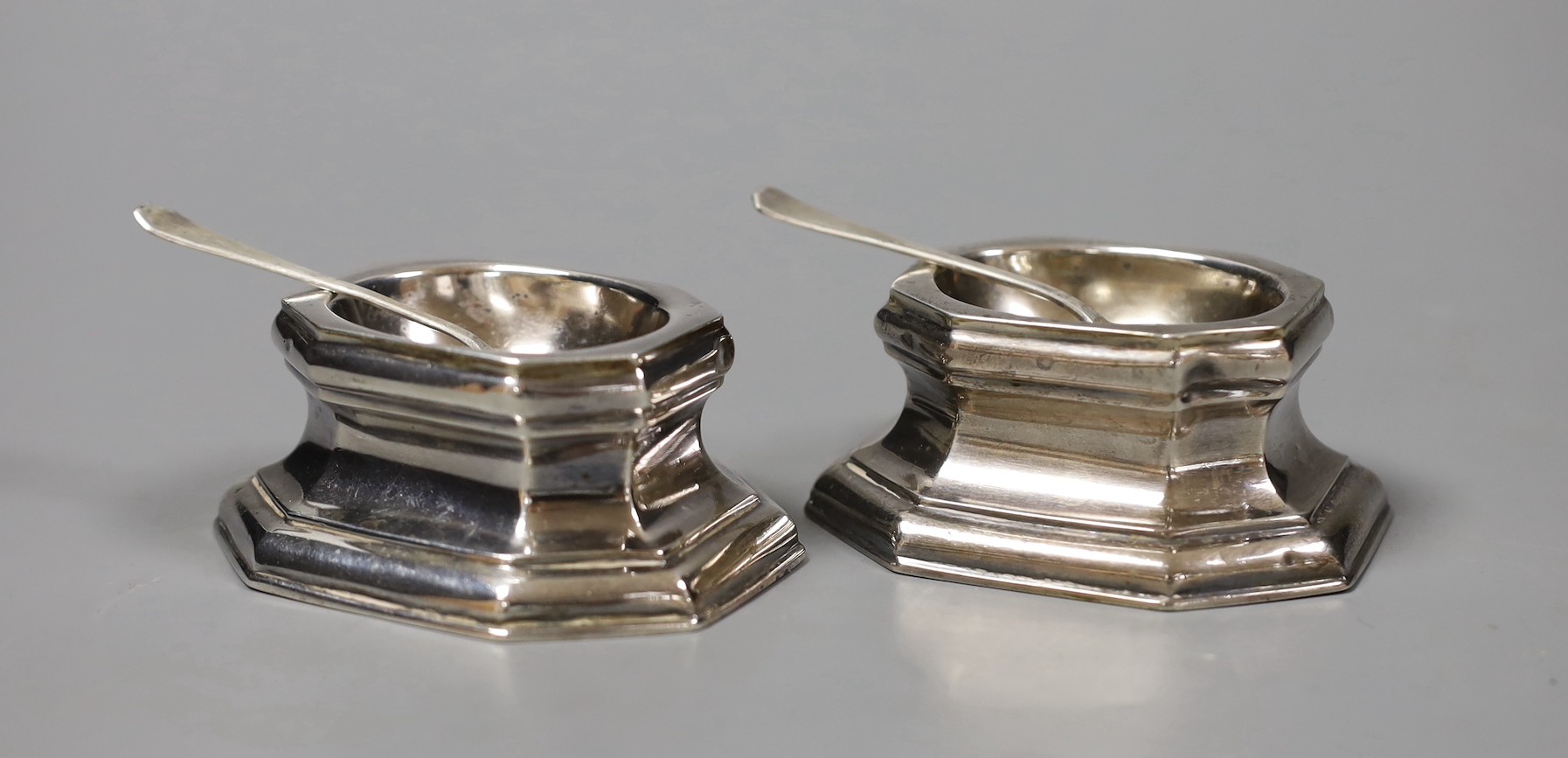 A pair of late Victorian Britannia standard silver trencher salts and pair of matching sterling silver spoons, Thomas Bradbury & Sons, London, 1897/1900, length 81mm, 140 grams.